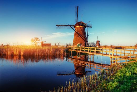 The road leading to the Dutch windmills from the canal in Rotterdam. Holland. Netherlands