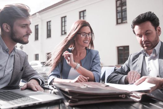 close up.business partners sit at a table on the street,