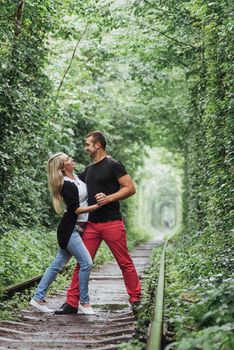 Loving couple on the iron road. Ukraine. Klevan