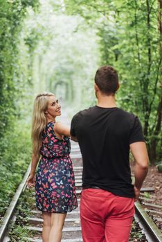 Loving couple in love tunnel iron road.