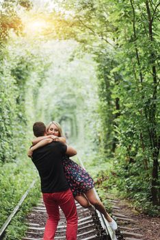 Loving couple in love tunnel iron road.