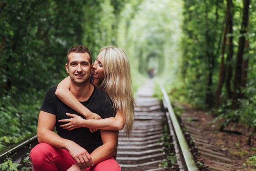 Loving couple in love tunnel iron road.