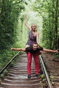 Loving couple in love tunnel iron road.