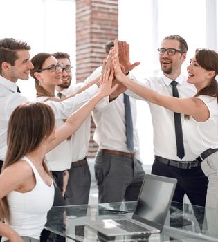 young business team giving each other high five.the concept of teamwork