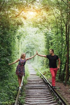 Loving couple in love tunnel iron road.