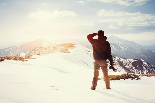 tourist looks at the landscape. Photographer on top of mountain. Spring landscape. Carpathians Ukraine Europe