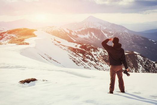 tourist looks at the landscape. Beautiful sunset. Spring landscape. Carpathians Ukraine Europe