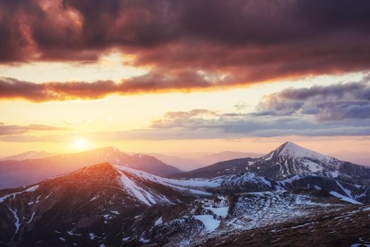 Colorful spring sunset over the mountain ranges in the national park Carpathians. Ukraine, Europe.