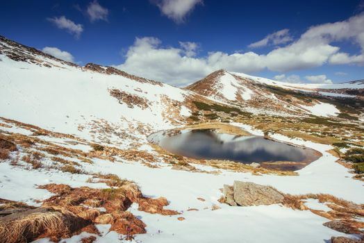 Mountain Lake. Reflection of sky in water. Spring landscape. Carpathians Ukraine Europe