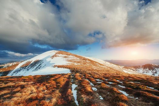 Spring mountain landscape. Snowy Mountains. Beautiful cumulus clouds. Carpathians Ukrain Europe