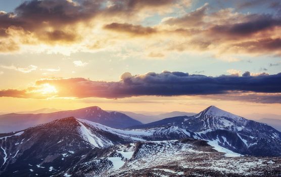 Colorful spring sunset over the mountain ranges in the national park Carpathians. Ukraine, Europe.