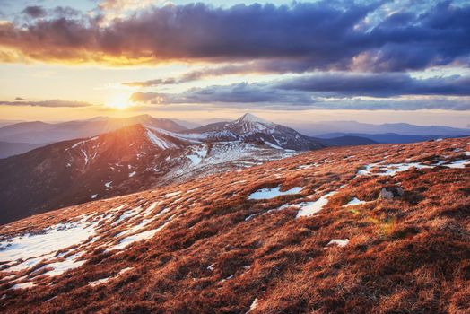 Colorful spring sunset over the mountain ranges in the national park Carpathians. Ukraine, Europe.