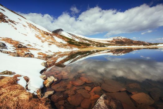 Lake between mountains. Spring landscape. Carpathians Ukraine Europe