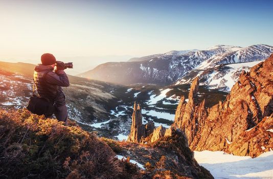 tourist looks at the landscape. Beautiful sunset. Spring landscape. Carpathians Ukraine Europe