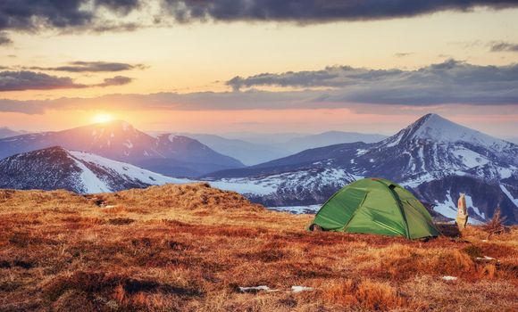 The tent is made up of green in the Carpathians. Spring mountain landscape. Ukraine. Europe.