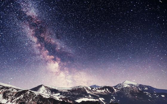 Spring mountain landscape. Fantastic starry sky. Carpathians Ukraine Europe