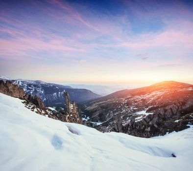 Colorful spring sunset over the mountain ranges in the national park Carpathians. Ukraine, Europe.