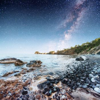 Fantastic panoramic view of the rocky beach. Starry sky. Turkey.