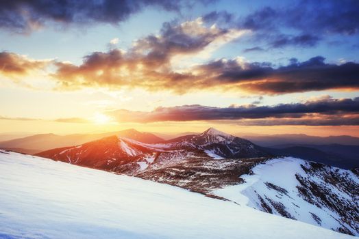 Colorful spring sunset over the mountain ranges in the national park Carpathians. Ukraine, Europe.