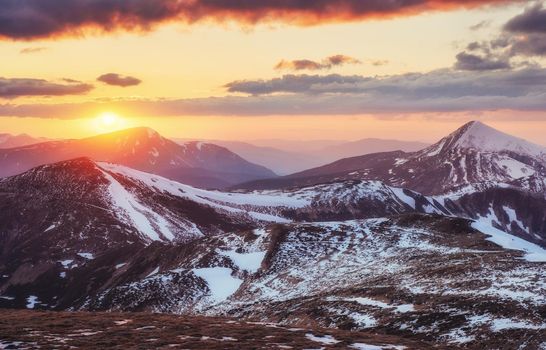 Colorful spring sunset over the mountain ranges in the national park Carpathians. Ukraine, Europe.