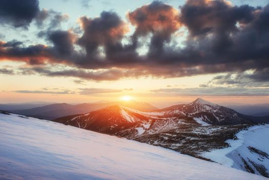 Colorful spring sunset over the mountain ranges in the national park Carpathians. Ukraine, Europe.