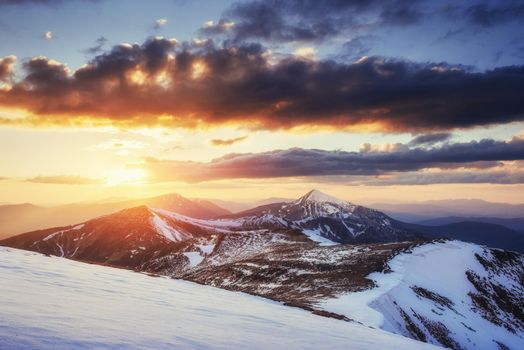 Colorful spring sunset over the mountain ranges in the national park Carpathians. Ukraine, Europe.