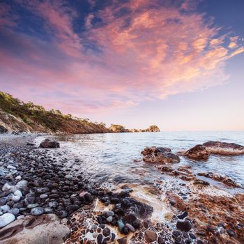 Fantastic panoramic view of the rocky coast of the sea in the evening at sunset. Turkey