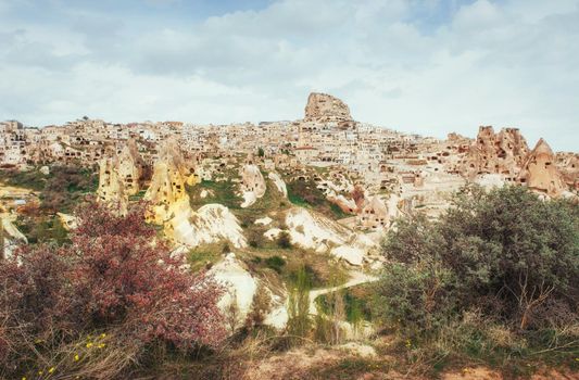 Ancient town and a castle of Uchisar dug from a mountains after sunrise, Cappadocia, Turkey