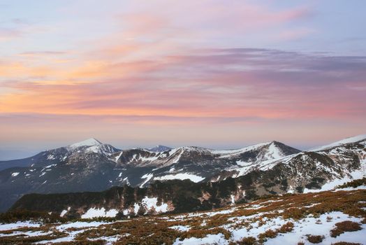 Colorful spring sunset over the mountain ranges in the national park Carpathians. Ukraine, Europe.