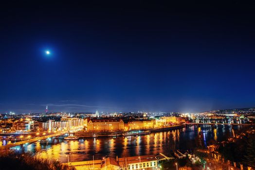 The magnificent Prague Castle at night along the River Vltava.