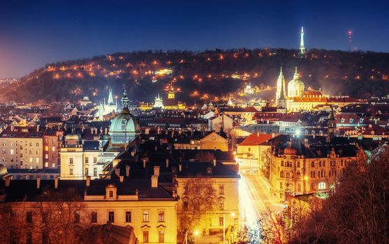 The magnificent Prague Castle at night along the River Vltava.