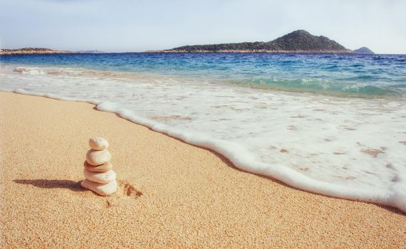 Scenic view of sandy beach and surf waves on the shore