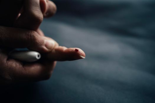 medicine, diabetes, blood glucose, health care and people concept - close up of woman finger with blood drop