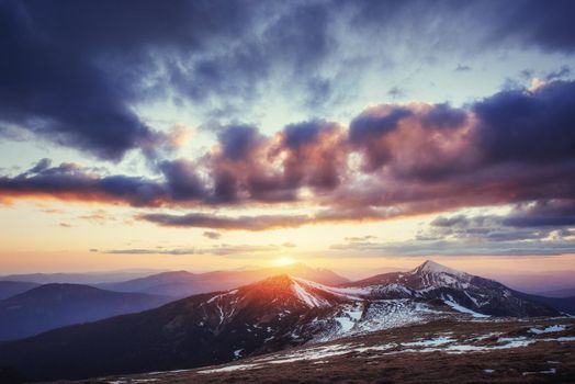 Colorful spring sunset over the mountain ranges in the national park Carpathians. Ukraine, Europe.