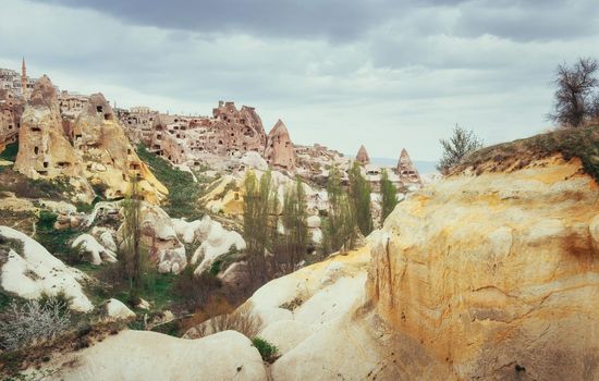 Ancient town and a castle of Uchisar dug from a mountains after sunrise, Cappadocia, Turkey