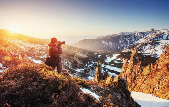tourist looks at the landscape. Beautiful sunset. Spring landscape. Carpathians Ukraine Europe