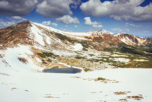 Lake between mountains. Spring landscape. Carpathians Ukraine Europe