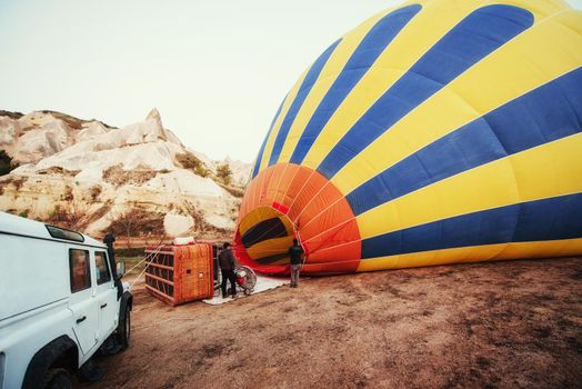 Cappadocia, Turkey. The first crew of flame and heat for inflating the balloon before launch. Balloon is one of the most famous of that trip will have to do in Cappadocia