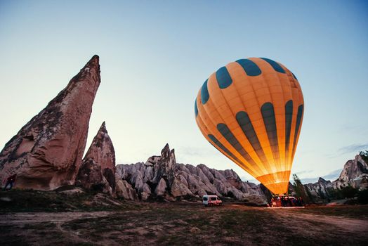 Cappadocia, Turkey. The first crew of flame and heat for inflating the balloon before launch. Balloon is one of the most famous of that trip will have to do in Cappadocia