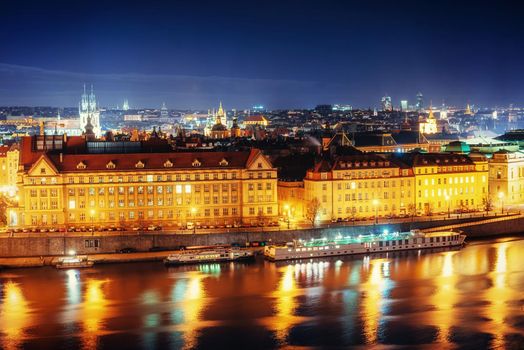 The magnificent Prague Castle at night along the River Vltava.