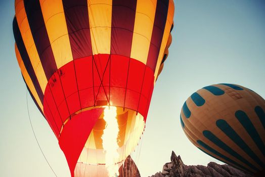 Cappadocia, Turkey. The first crew of flame and heat for inflating the balloon before launch. Balloon is one of the most famous of that trip will have to do in Cappadocia