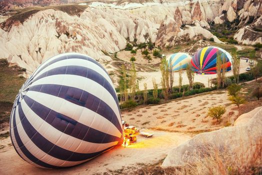 Cappadocia, Turkey. The first crew of flame and heat for inflating the balloon before launch. Balloon is one of the most famous of that trip will have to do in Cappadocia