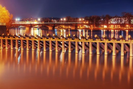 Scenic view of bridges on the Vltava river and of the historical center of Prague: buildings and landmarks of old town with red rooftops.