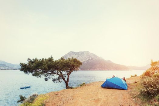 Blue tent on sandy wild beach at sunset light Turkey