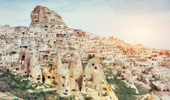 Ancient town and a castle of Uchisar dug from a mountains after sunrise, Cappadocia, Turkey