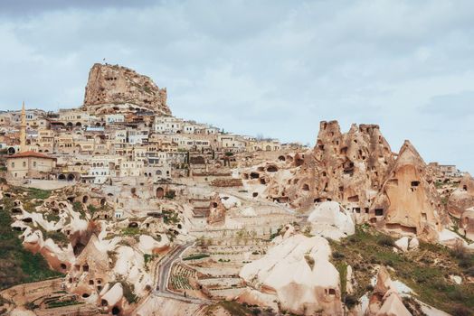 Ancient town and a castle of Uchisar dug from a mountains after sunrise, Cappadocia, Turkey
