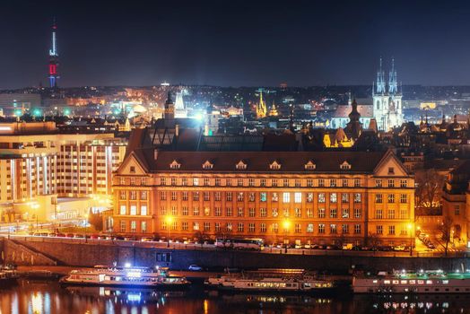 The magnificent Prague Castle at night along the River Vltava.