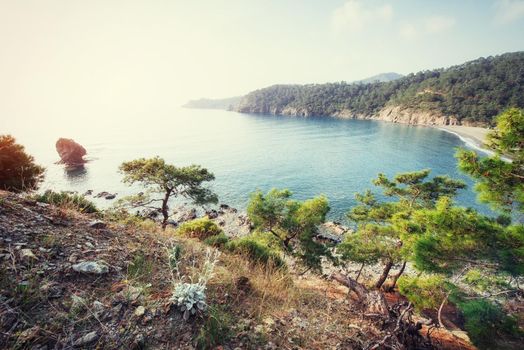 Beautiful sandy road that video into the mountains overlooking the sea.