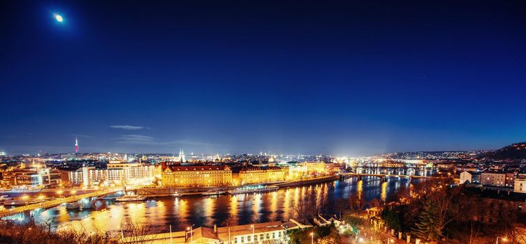 The magnificent Prague Castle at night along the River Vltava.