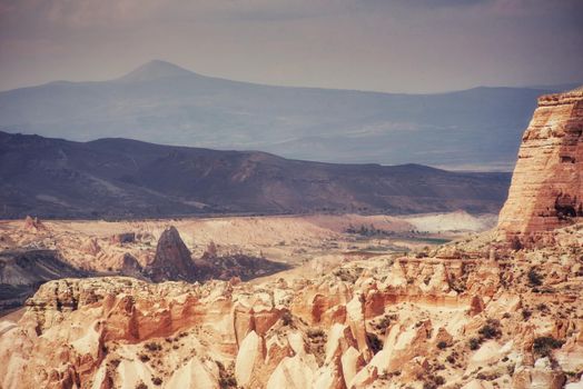 Beauty geological formations in Cappadocia, Turkey. Cappadocia with its valley, ravine, hills, located between the volcanic mountains in Goreme National Park.